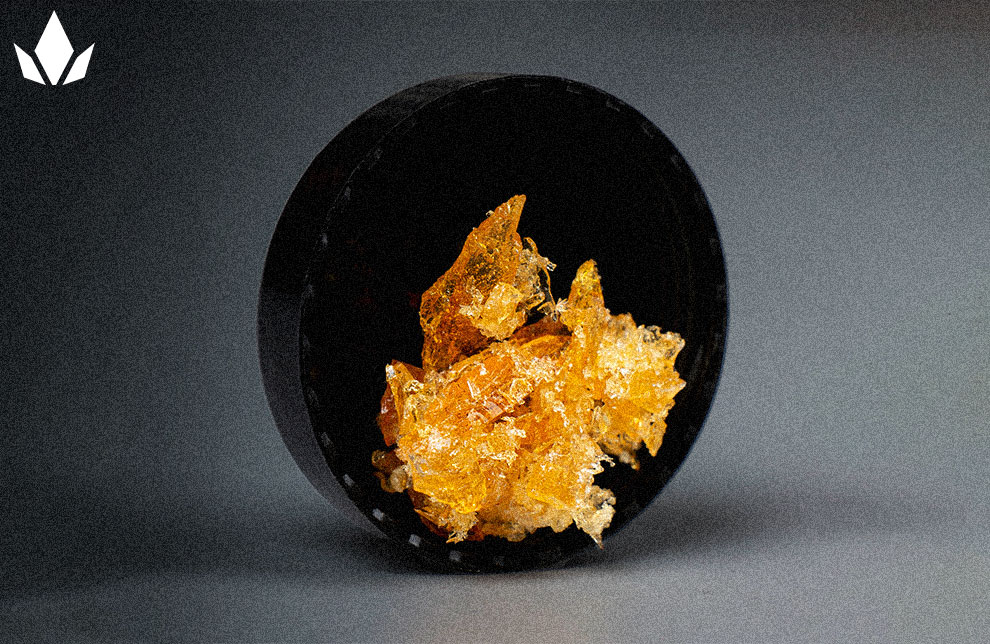 Cannabis concentrate in a black container.