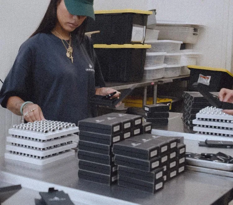 Girl workers loading THCA prerolls and THCP carts