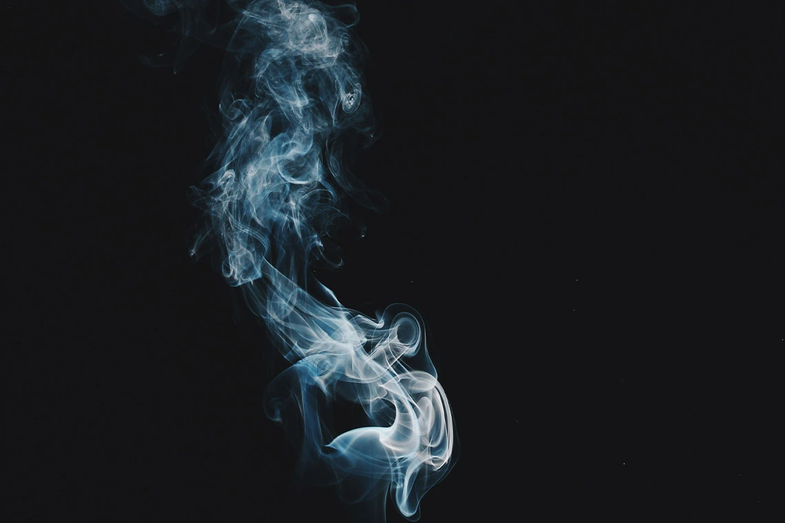 Smoke Hanging in the Air Against a Black Background