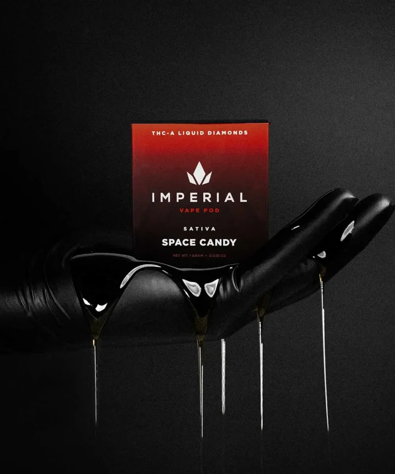 Imperial extraction thca liquid diamond vape pen Space Candy being held in a hand with oil dripping