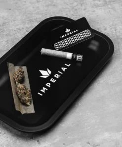 Imperial Extraction thca flower rolling tray with thca flower preroll, grinder, and preroll paper resting on top.