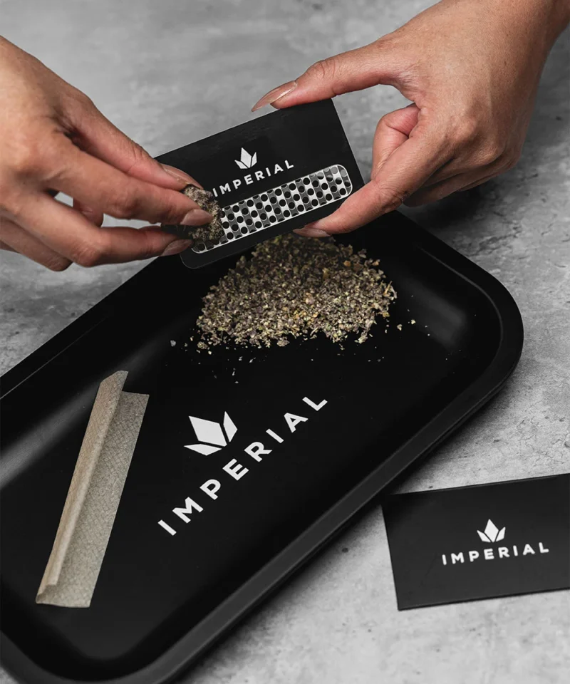 Imperial Extraction THCA flower being grinded by Imperial grinder card.