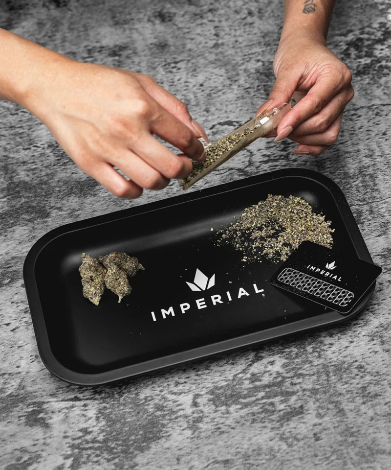 Imperial Extraction thca flower rolling tray with thca flower preroll, grinder, and preroll paper resting on top.